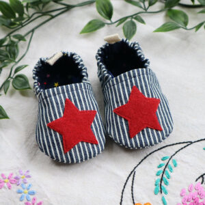 Handmade baby shoes in blue and white striped denim with red star appliqué, fully lined cotton booties with elastic heels and non-slip soles.