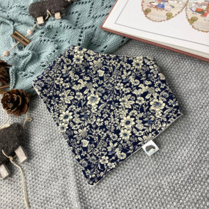 Handmade baby dribble bib in navy floral cotton with absorbent fleece backing, bandana style with adjustable poppers