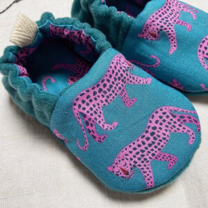 Handmade baby shoes in teal wool mix with cheetah print uppers, lined in cotton, with elastic heel and natural suede non-slip soles for toddlers.