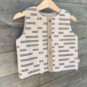 Handmade upcycled padded gilet for children, made from a repurposed duvet with light cotton wadding, fully lined with cotton and fastened with metal poppers.