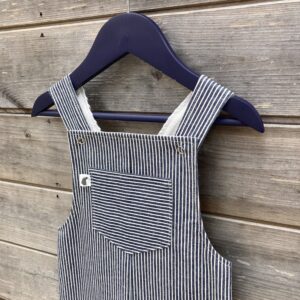 Handmade cotton denim dungarees in a classic blue and white stripe with bib pocket and metal poppers.