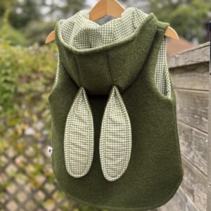 Olive green boiled wool child’s gilet with green gingham lining & bunny ears on the hood