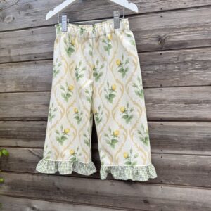 Handmade girl’s trousers in vintage floral fabric with green gingham frill hem and elastic waistband.